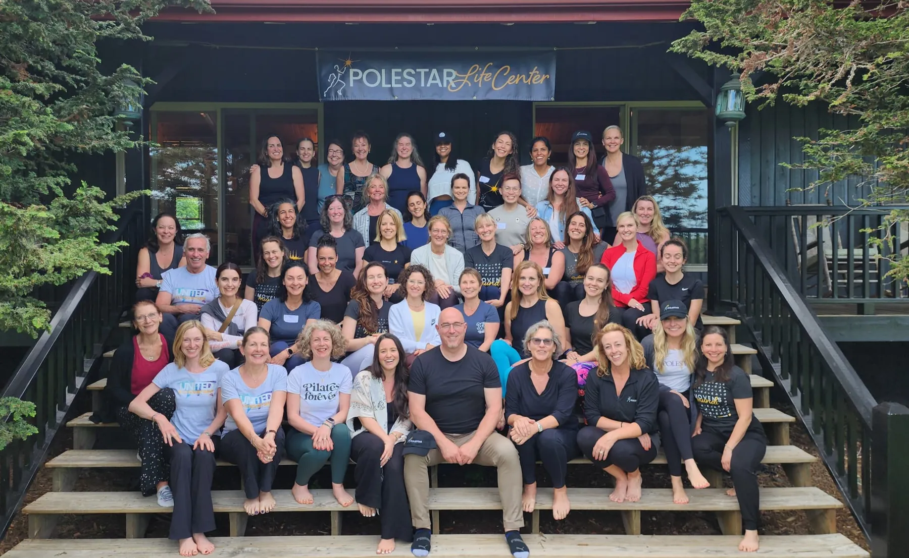 Polestar Pilates faculty and trainees gathered on the steps of a Polestar Life Center training retreat.