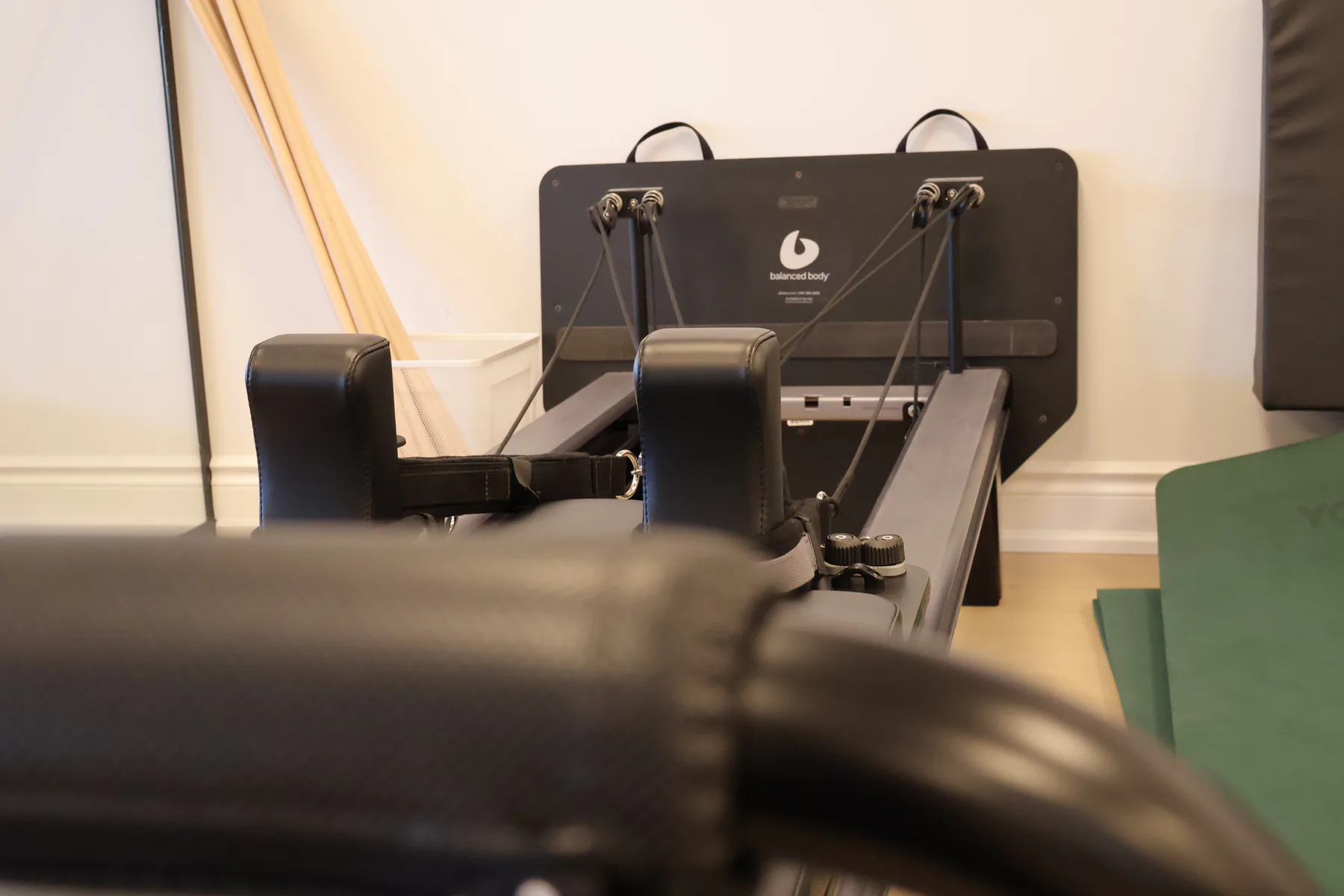 Konnector® apparatus attached to a reformer for connected, full-body Pilates.