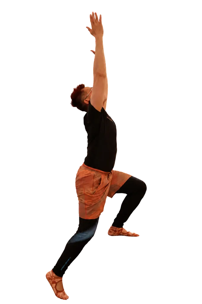 Gary Fok reaching upward in a long split stance, representing his journey from instructor to educator.