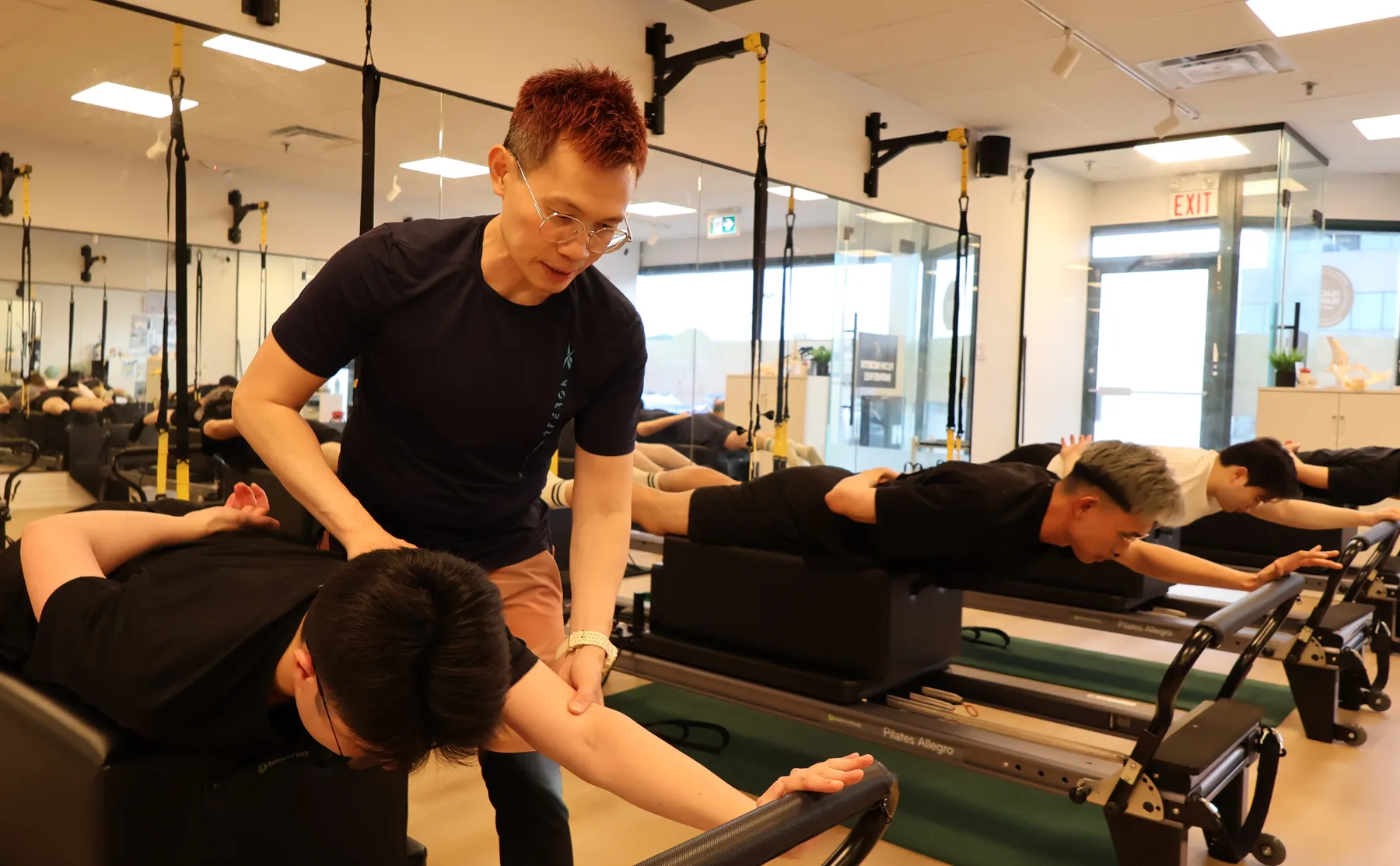 Gary Fok leading a small group reformer class at Motion Vitality Pilates in Markham.